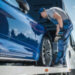 car-repossession-worker-securing-vehicle-on-his-towing-truck.jpg